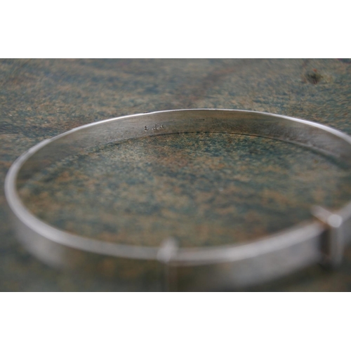 594 - A child's silver identity bangle.