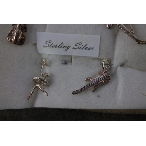 609 - Five sterling silver charms.