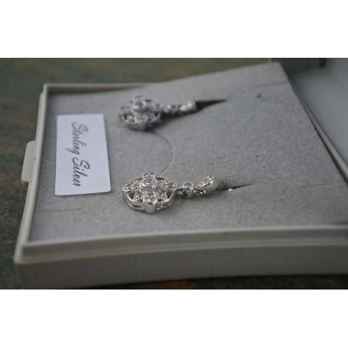 619 - A pair of sterling silver drop cluster earrings.