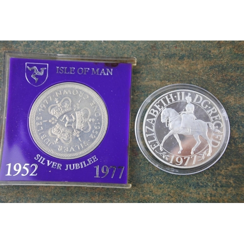 640 - A cased Isle of Man commemorative coin for the Silver Jubilee and another.