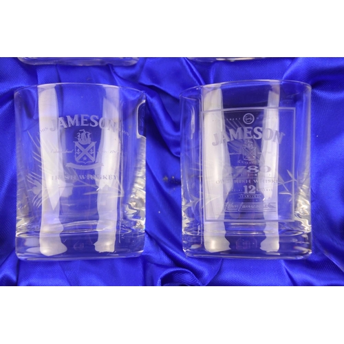 673 - A boxed set of Duiske Irish crystal glasses with whiskey brands to include Jameson, Black Bush, John... 