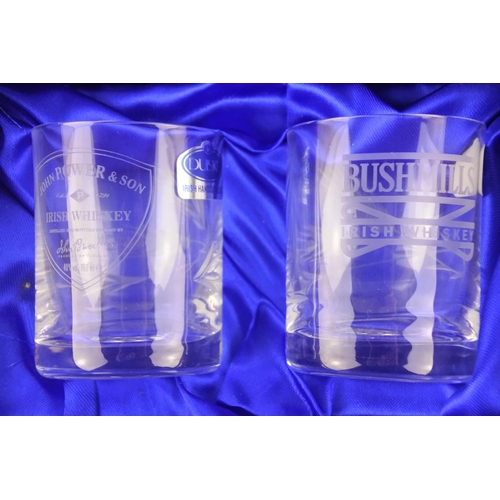 673 - A boxed set of Duiske Irish crystal glasses with whiskey brands to include Jameson, Black Bush, John... 