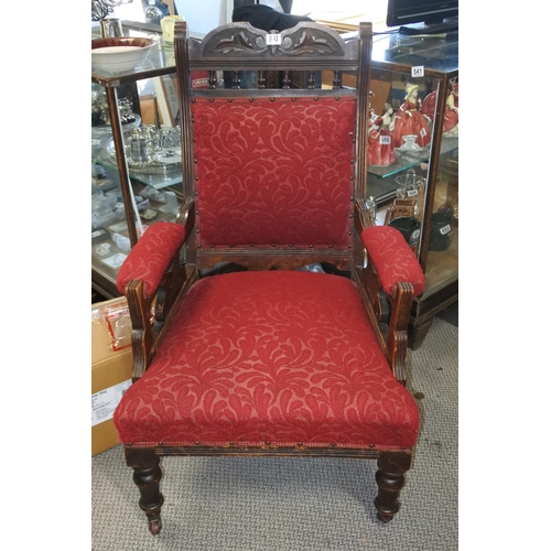 687 - An antique upholstered armchair.