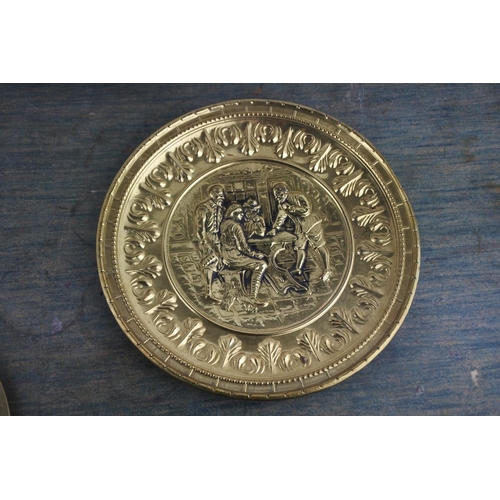 709 - A vintage brass plaque of a tavern scene and another brass lacquered plate.