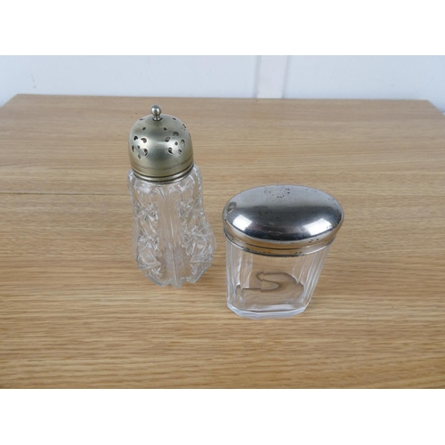 753 - An EPNS lidded glass sugar shaker and container.