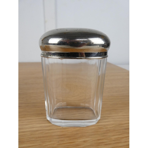 753 - An EPNS lidded glass sugar shaker and container.