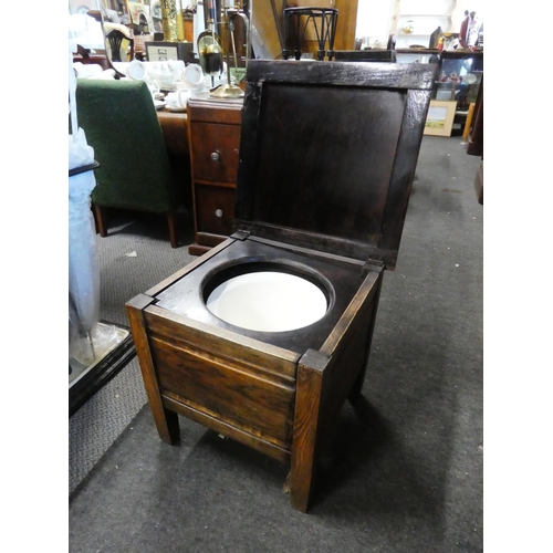 765 - An antique oak commode/stool.