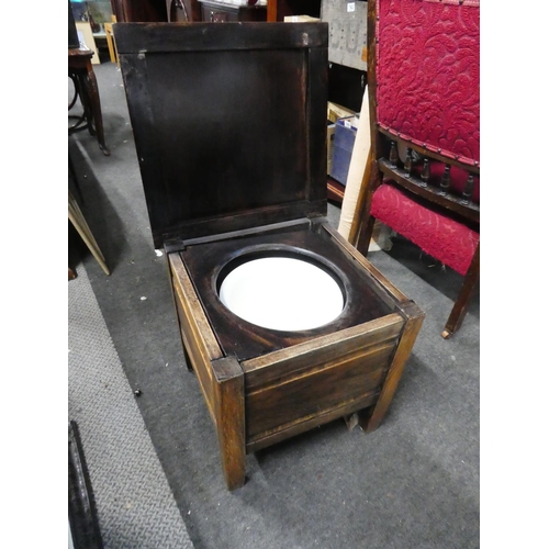 765 - An antique oak commode/stool.