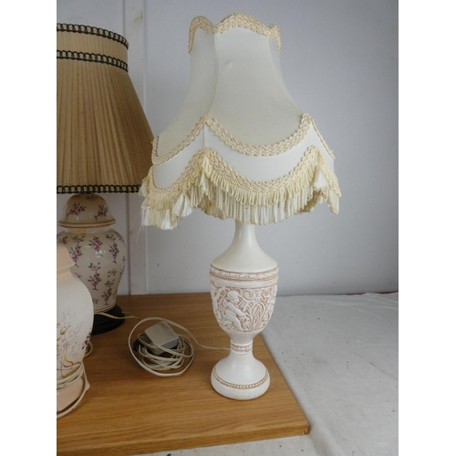 779 - A pair of cupid style table lamps and two others.