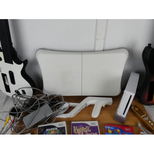 795 - A collection of Wii games, controllers, guitars and more.