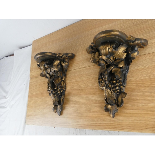 823 - A pair of decorative wall brackets.