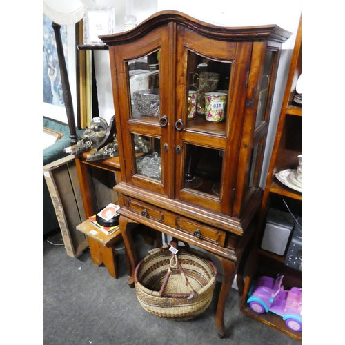 829 - A small wooden two door display cabinet with drawer, measuring 127cm x 59cm x 30cm approximately.