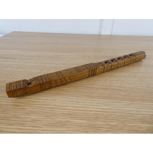 833 - A highly carved wooden recorder.