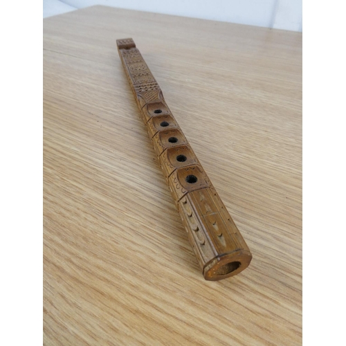 833 - A highly carved wooden recorder.