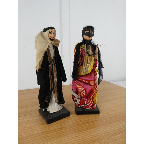 852 - Two ornamental dolls on wooden stands.