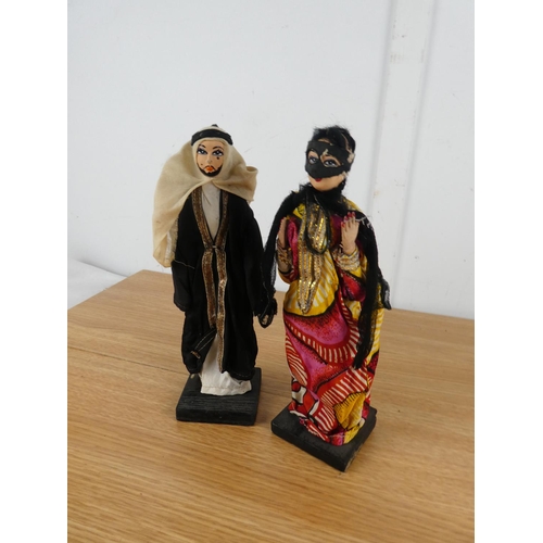 852 - Two ornamental dolls on wooden stands.