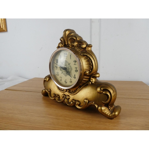 874 - A Quartz mantle clock in a plastic case/.