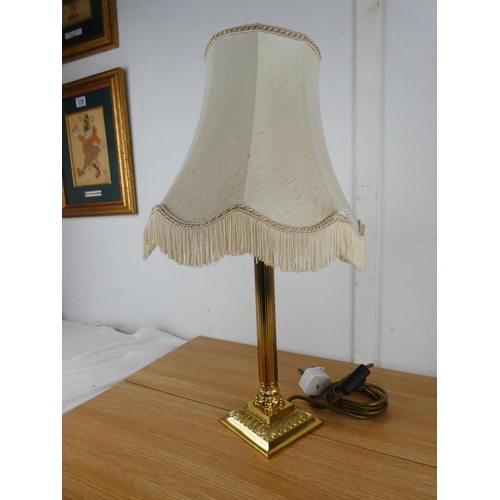 876 - A Corinthian style table lamp and shade.