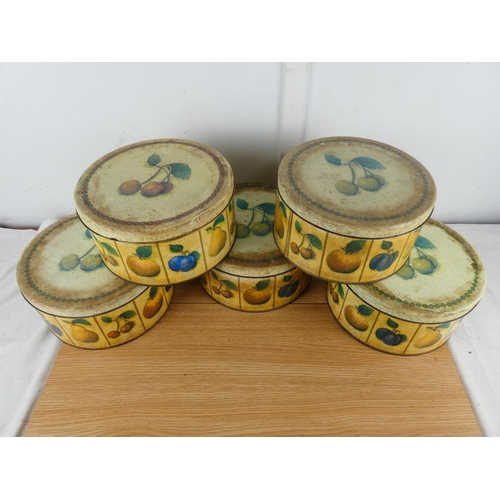 885 - A set of five lidded cake tins with fruit design.