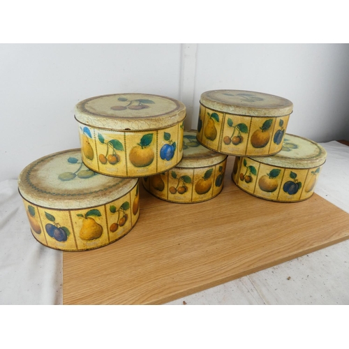 885 - A set of five lidded cake tins with fruit design.