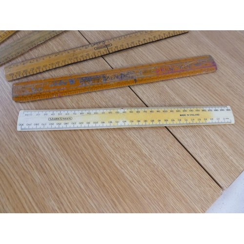 894 - A collection of wooden rulers.