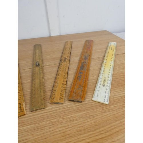 894 - A collection of wooden rulers.