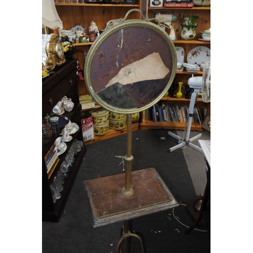 923 - An antique mahogany and brass mirror on stand (in need of restoration).