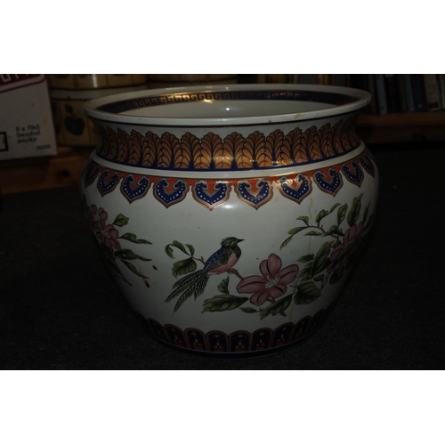 930 - A large stunning floral and bird patterned plant pot.