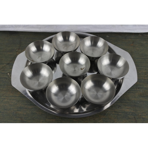 933 - A set of eight Viners stainless steel pudding bowl and a stainless steel serving tray.