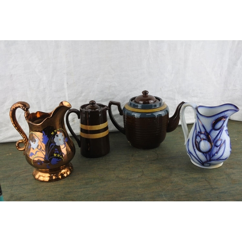 935 - A large antique glazed teapot (repair to spout), an antique glazed water pot, and two other jugs.