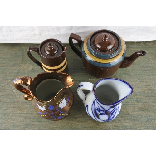 935 - A large antique glazed teapot (repair to spout), an antique glazed water pot, and two other jugs.