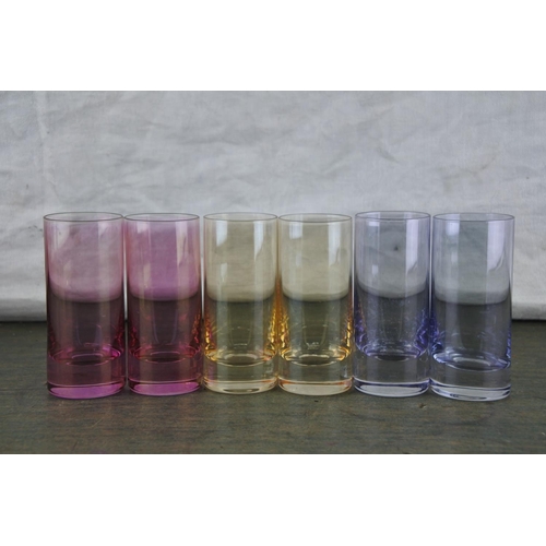 940 - A set of six coloured shot glasses.