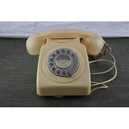 942 - A vintage cream rotary telephone.