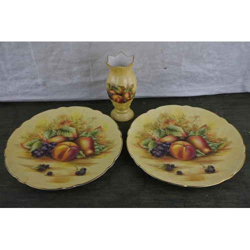 945 - A pair of Aynsley Orchard Gold wall plates and a Aynsley Orchard Gold vase.