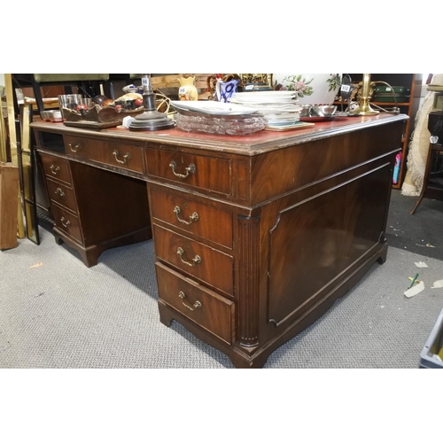 948 - A stunning mahogany partners desk with red leather top, measuring 77cm x 168cm x 116cm in size.