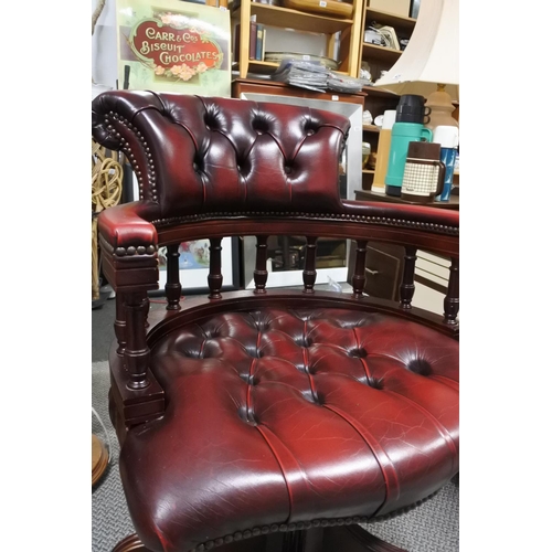 950 - A stunning upholstered ox blood leather captains swivel chair.