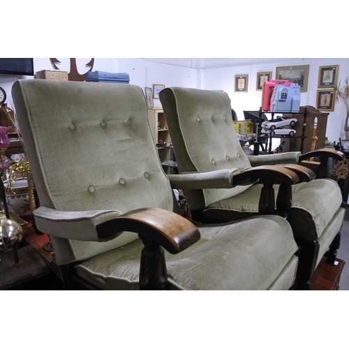 953 - A pair of upholstered fireside armchairs.