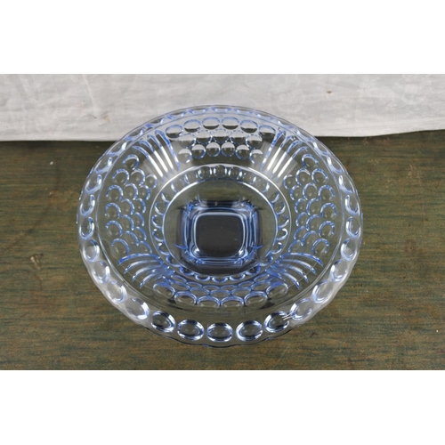 978 - A stunning vintage blue glass bowl on a black ceramic stand.