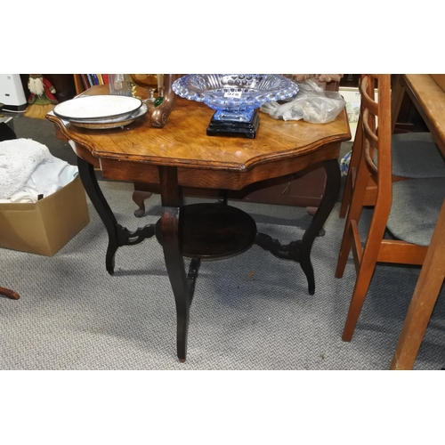 982 - A large antique oak topped table with scalloped edges and undershelf.