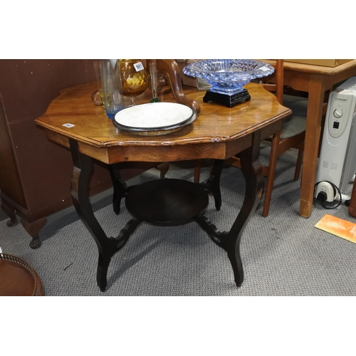 982 - A large antique oak topped table with scalloped edges and undershelf.