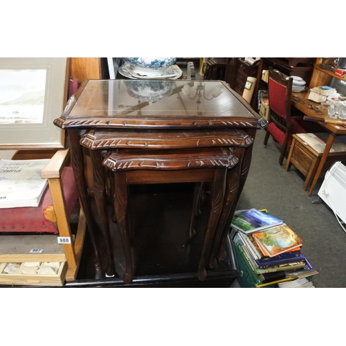 984 - A mahogany nest of tables with glass tops.