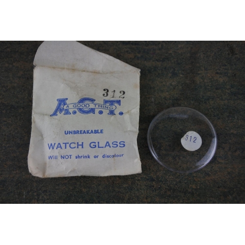 987 - A box of vintage watch glass covers.