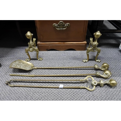 993 - A set of brass fire irons and dogs.