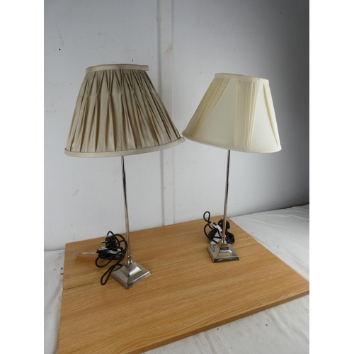 1004 - A pair of metal based table lamps and shades.