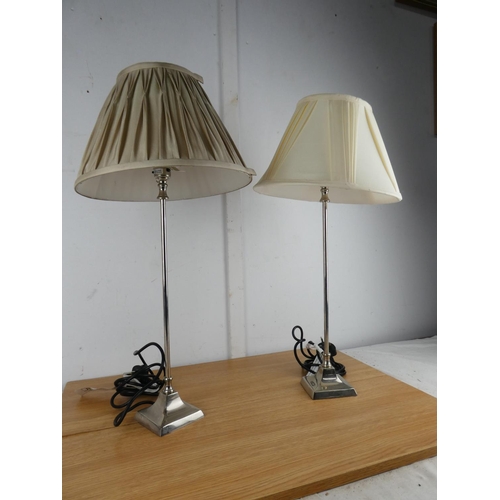 1004 - A pair of metal based table lamps and shades.