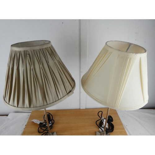 1004 - A pair of metal based table lamps and shades.