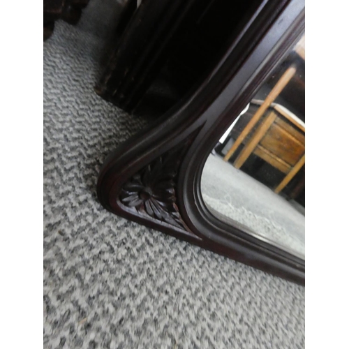 1016 - A mahogany framed wall mirror, measuring 102cm x 73cm in size.