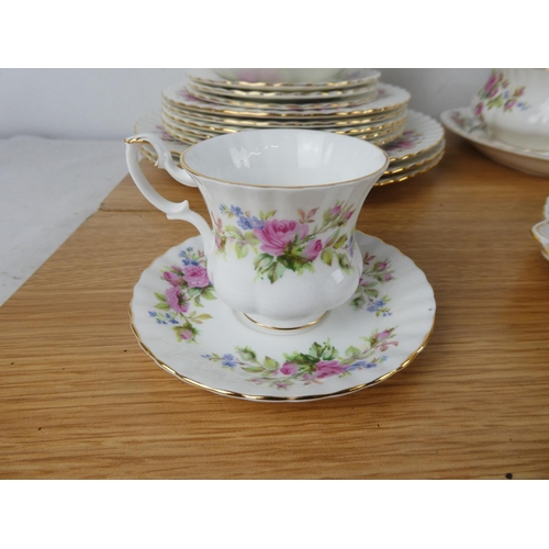 1034 - A large collection of Royal Albert 'Moss Rose' tea and dinner set.