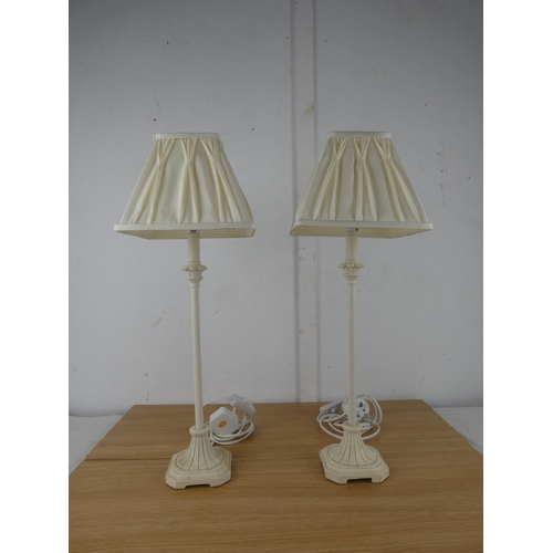 1055 - A pair of cream metal based table lamps and shades.