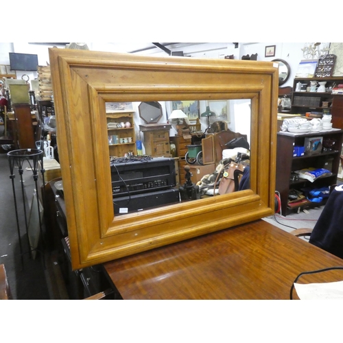 1058 - A large heavy pine framed mirror, measuring 120cm x 90cm in size.